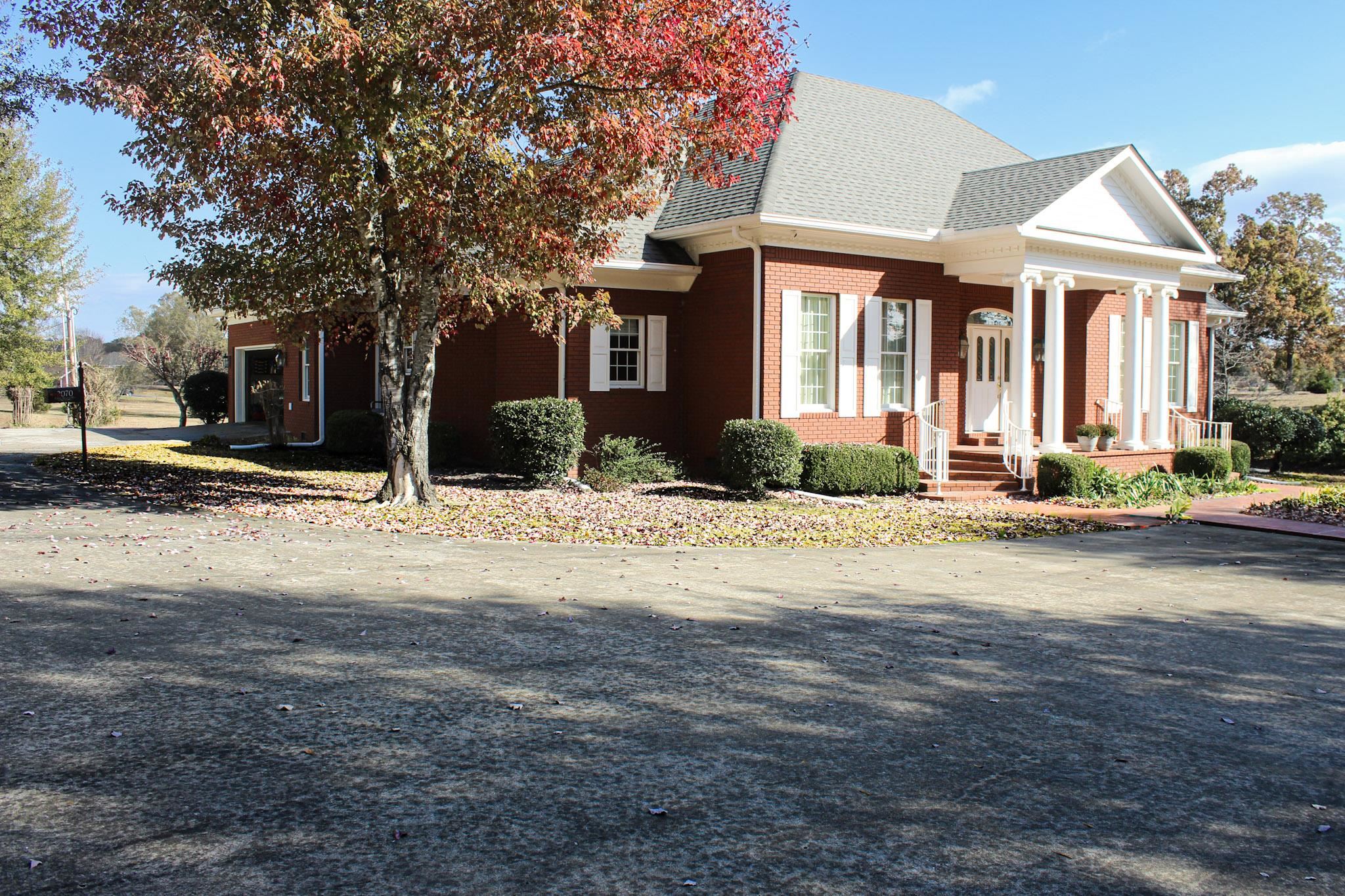 3070 Caney Branch Road Adamsville, TN 38310 - Photo 20 of 24 a front view of a house with a yard