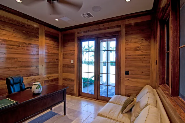 an aerial view of a house with a garden and lake view