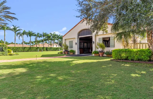 an aerial view of a house with a garden and lake view