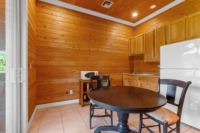 a view of a hallway with wooden floor and closet area
