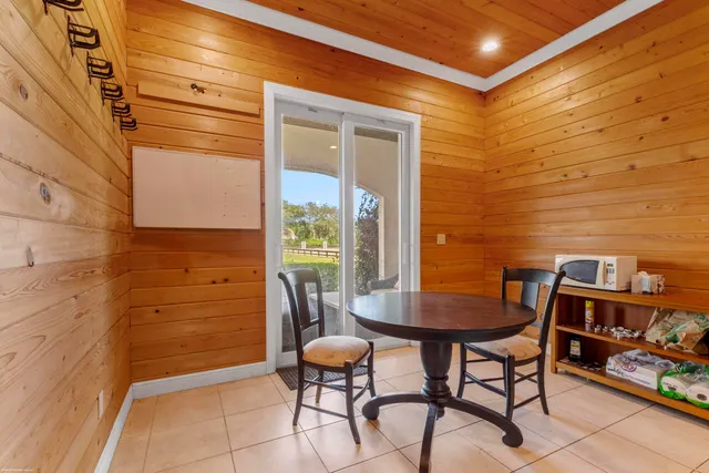 a bedroom with a bed couch and large window