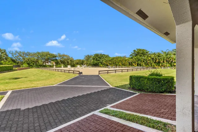 a en suite bathroom with a granite countertop tub and a large mirror