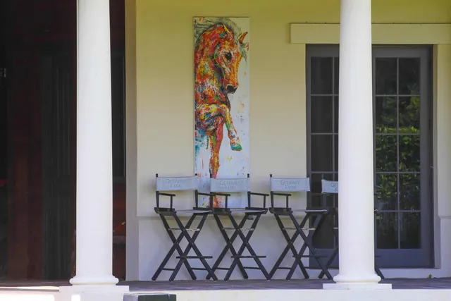 a bedroom with a bed couch mirror and window