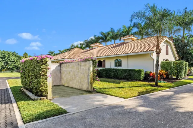 a bathroom with a sink a mirror and next to a window
