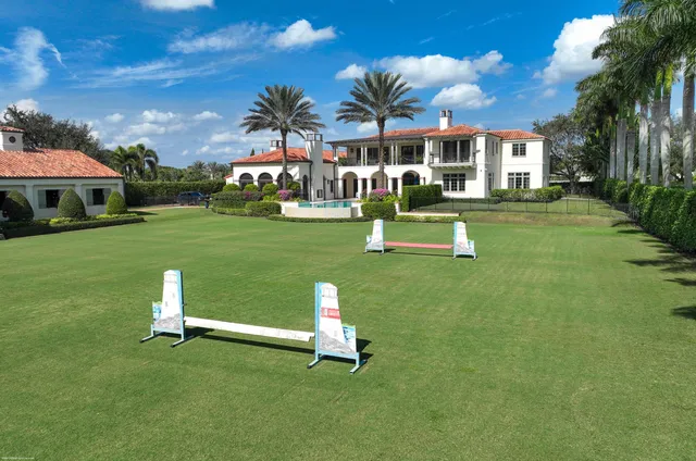 a front view of a house with a yard table and chairs