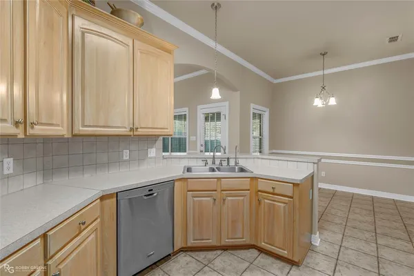 a view of a patio with table and chairs and potted plants