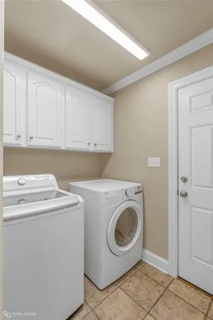a view of a backyard with large trees and wooden fence