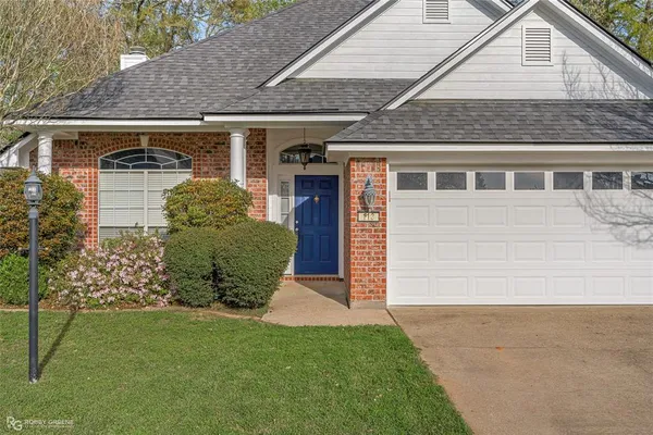 a view of a livingroom with a fireplace a chandelier a wooden table and chandelier