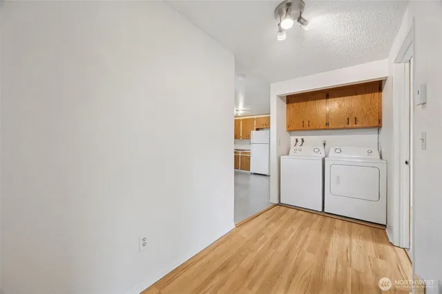 a view of a room with wooden floor and cabinet