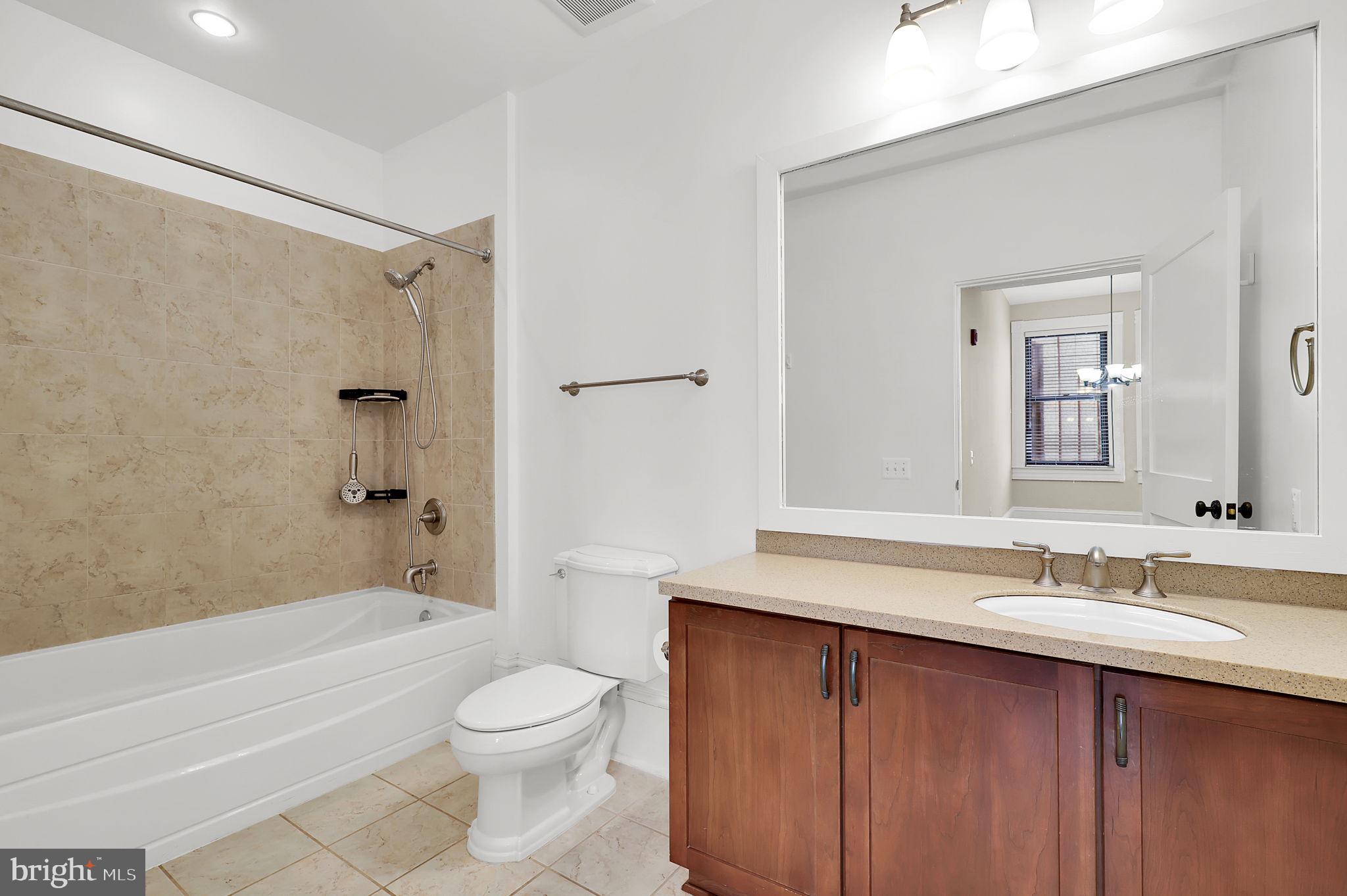 9610 Dewitt Drive, Unit SH205 Silver Spring, MD 20910 - Photo 12 of 59 a bathroom with a sink a toilet and shower