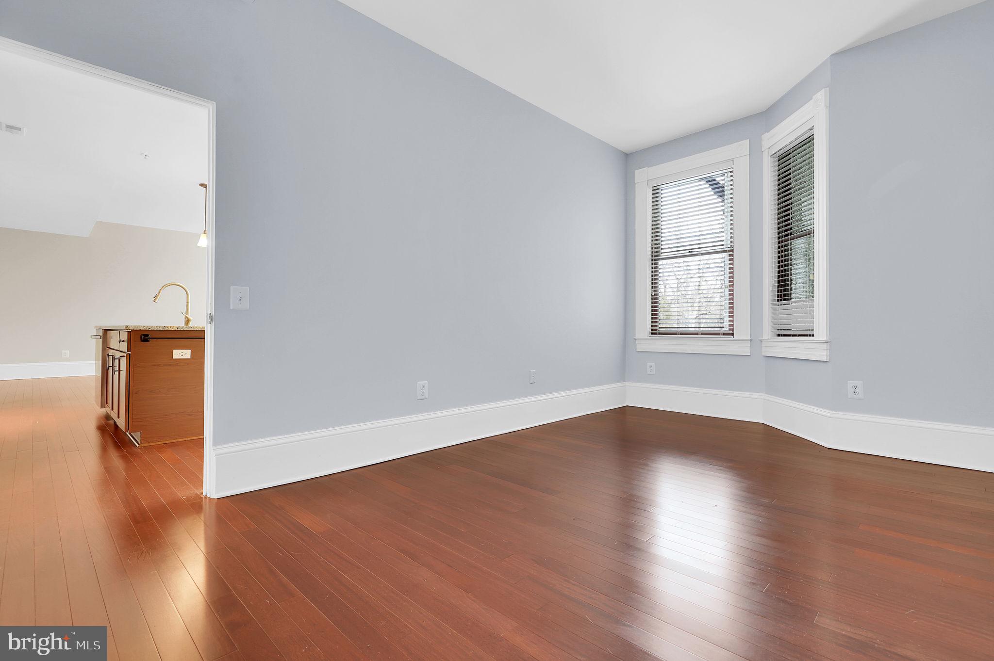 9610 Dewitt Drive, Unit SH205 Silver Spring, MD 20910 - Photo 14 of 59 an empty room with wooden floor and windows