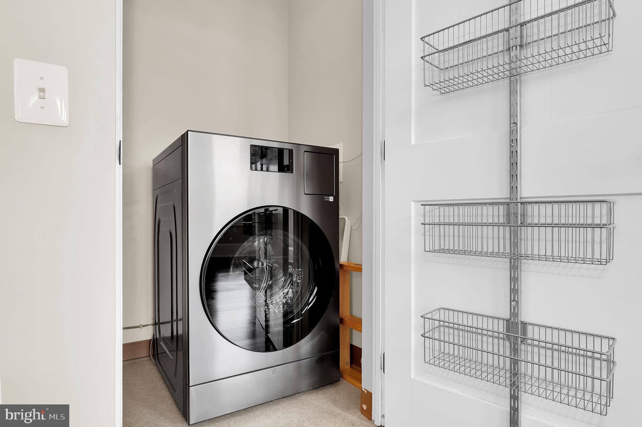 9610 Dewitt Drive, Unit SH205 Silver Spring, MD 20910 - Photo 21 of 59 a utility room with dryer and washer