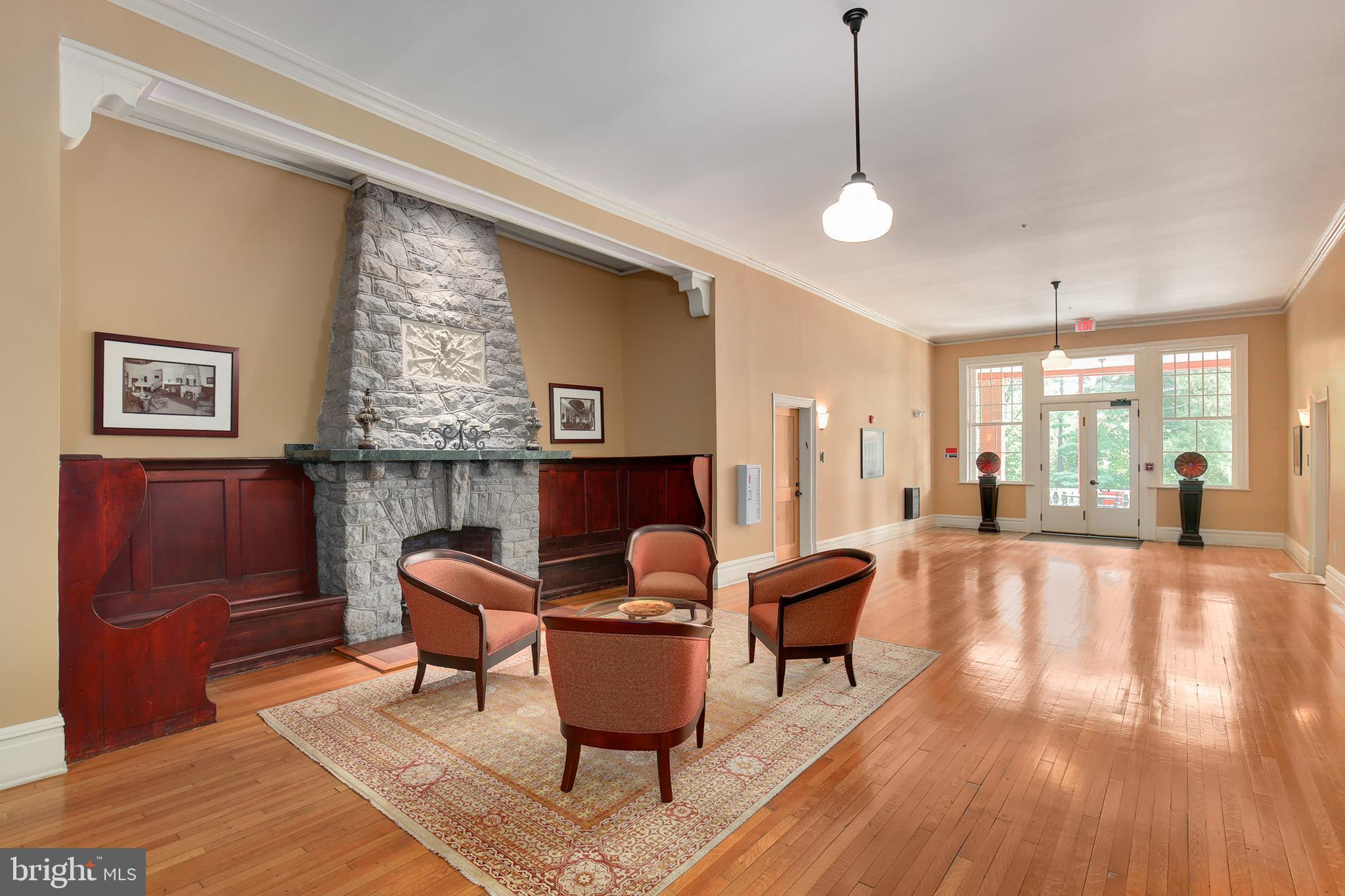9610 Dewitt Drive, Unit SH205 Silver Spring, MD 20910 - Photo 28 of 59 a living room with furniture and a wooden floor