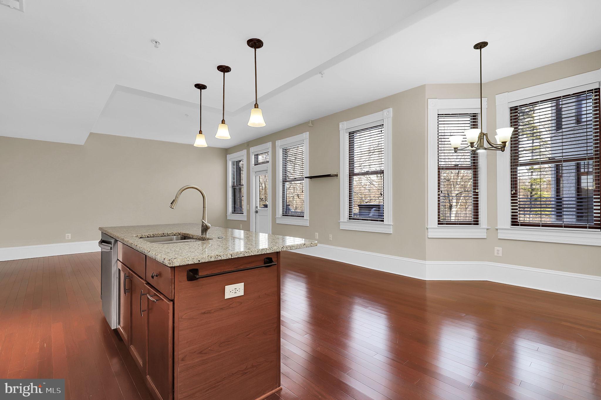 9610 Dewitt Drive, Unit SH205 Silver Spring, MD 20910 - Photo 6 of 59 a kitchen with stainless steel appliances granite countertop a sink a stove and a wooden floor