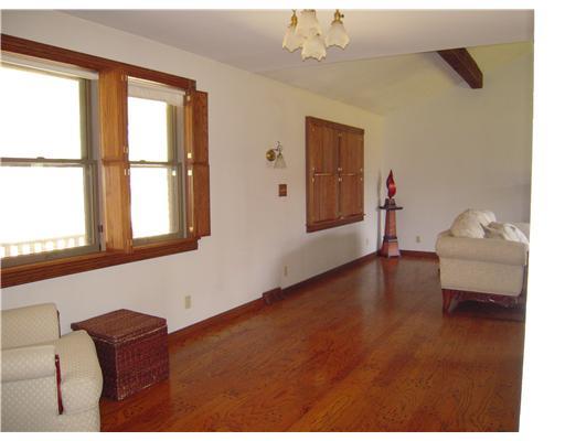 622 Boyers Road Boyers, PA 16020 - Photo 7 of 18 Living Room. L shaped living room with custom made wood shutters.