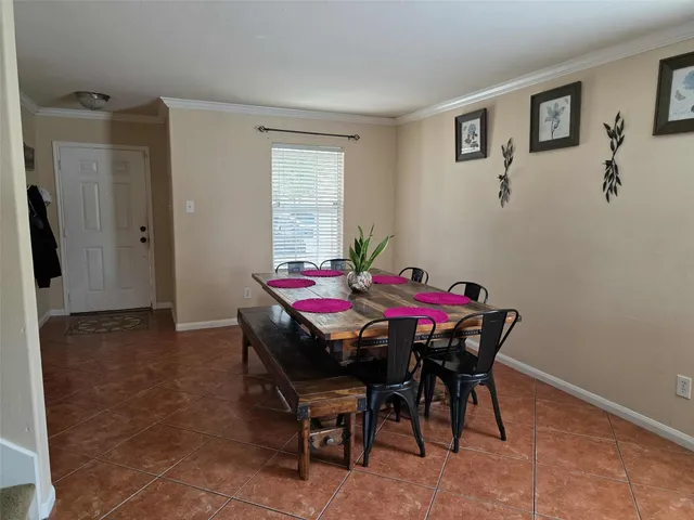 a dining room with furniture and window