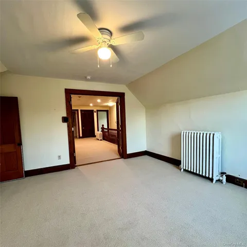 a view of an empty room with a fireplace