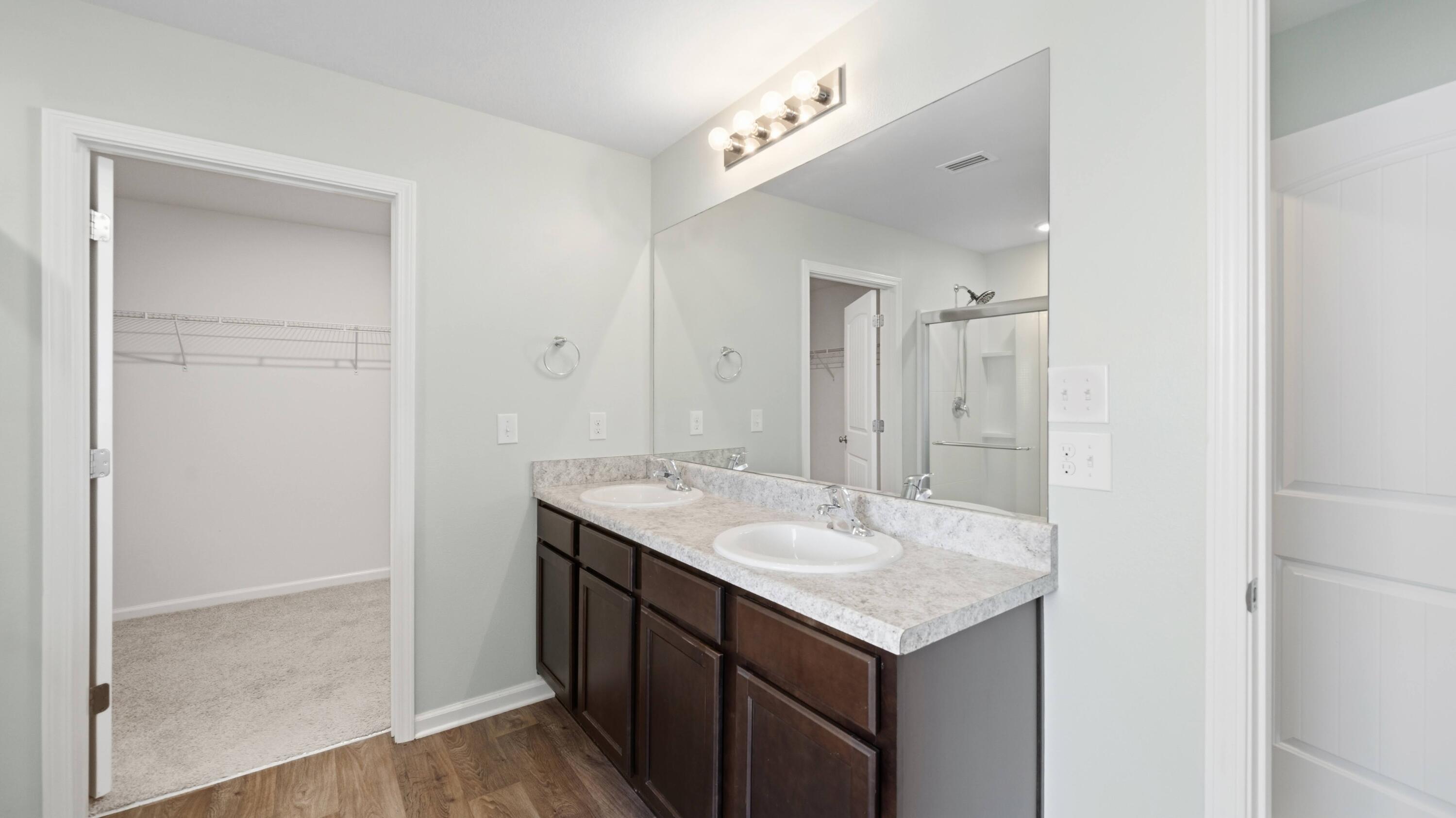 3927 Alva Thomas Road Panama City, FL 32404 - Photo 16 of 46 a bathroom with a sink vanity and a mirror