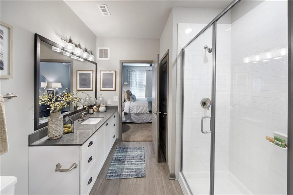 6919 Peachtree Dunwoody Road, Unit 131 Sandy Springs, GA 30328 - Photo 16 of 43 a very nice looking room with a mirror