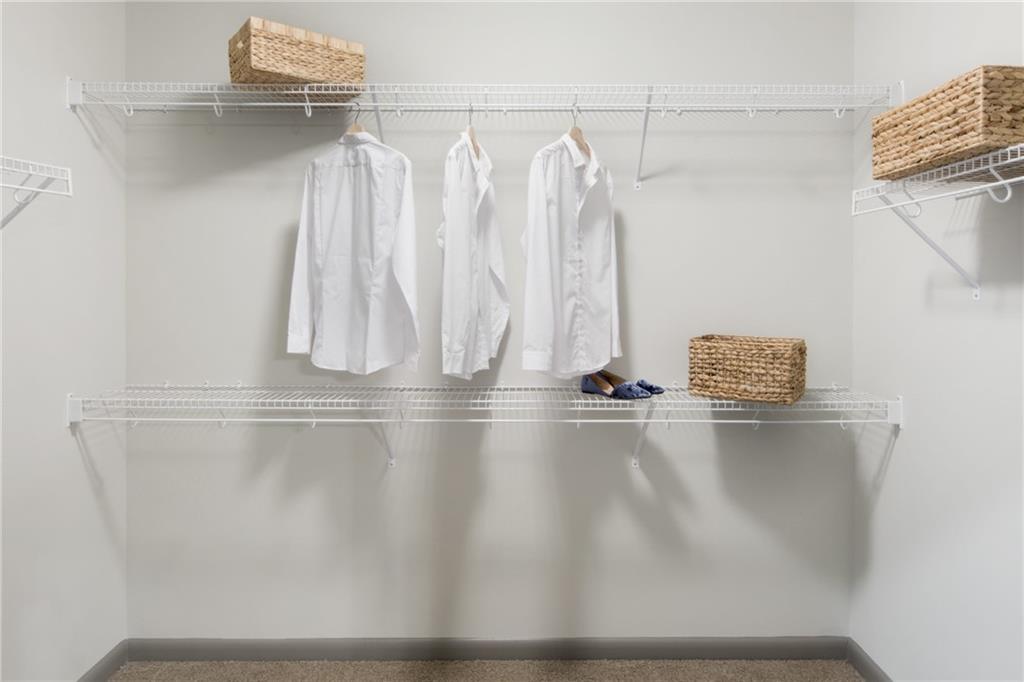 6919 Peachtree Dunwoody Road, Unit 131 Sandy Springs, GA 30328 - Photo 19 of 43 a view of walk in closet with clothes
