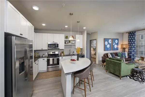 a kitchen with a refrigerator and a stove top oven