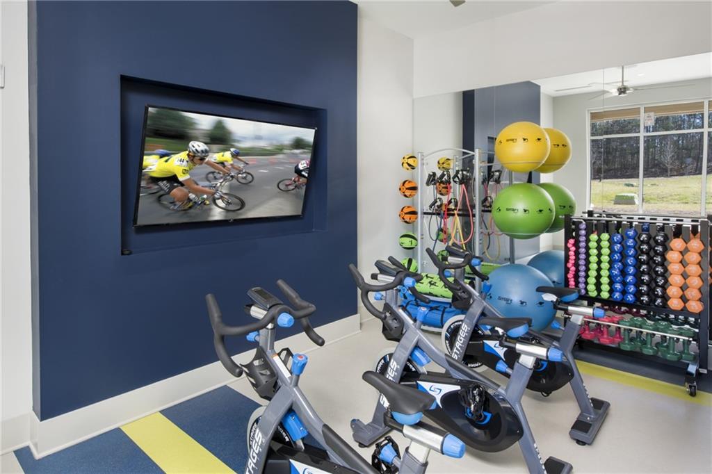 6919 Peachtree Dunwoody Road, Unit 131 Sandy Springs, GA 30328 - Photo 41 of 43 a living room with furniture and flowers