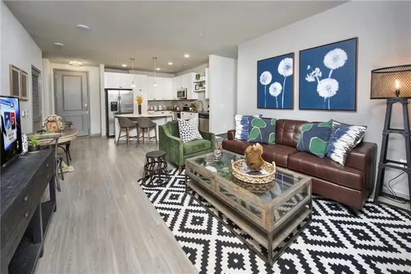 a living room with furniture and wooden floor