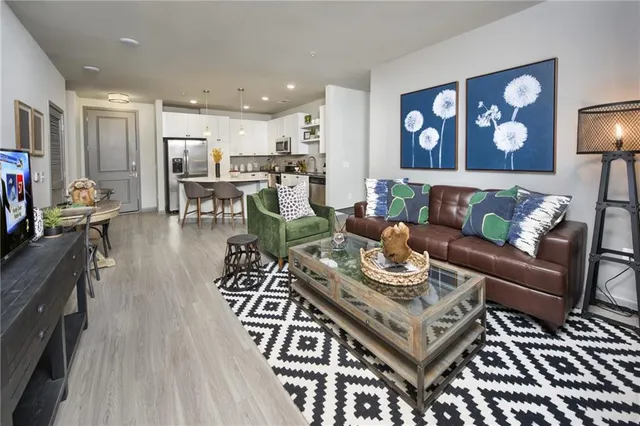 a living room with furniture and wooden floor