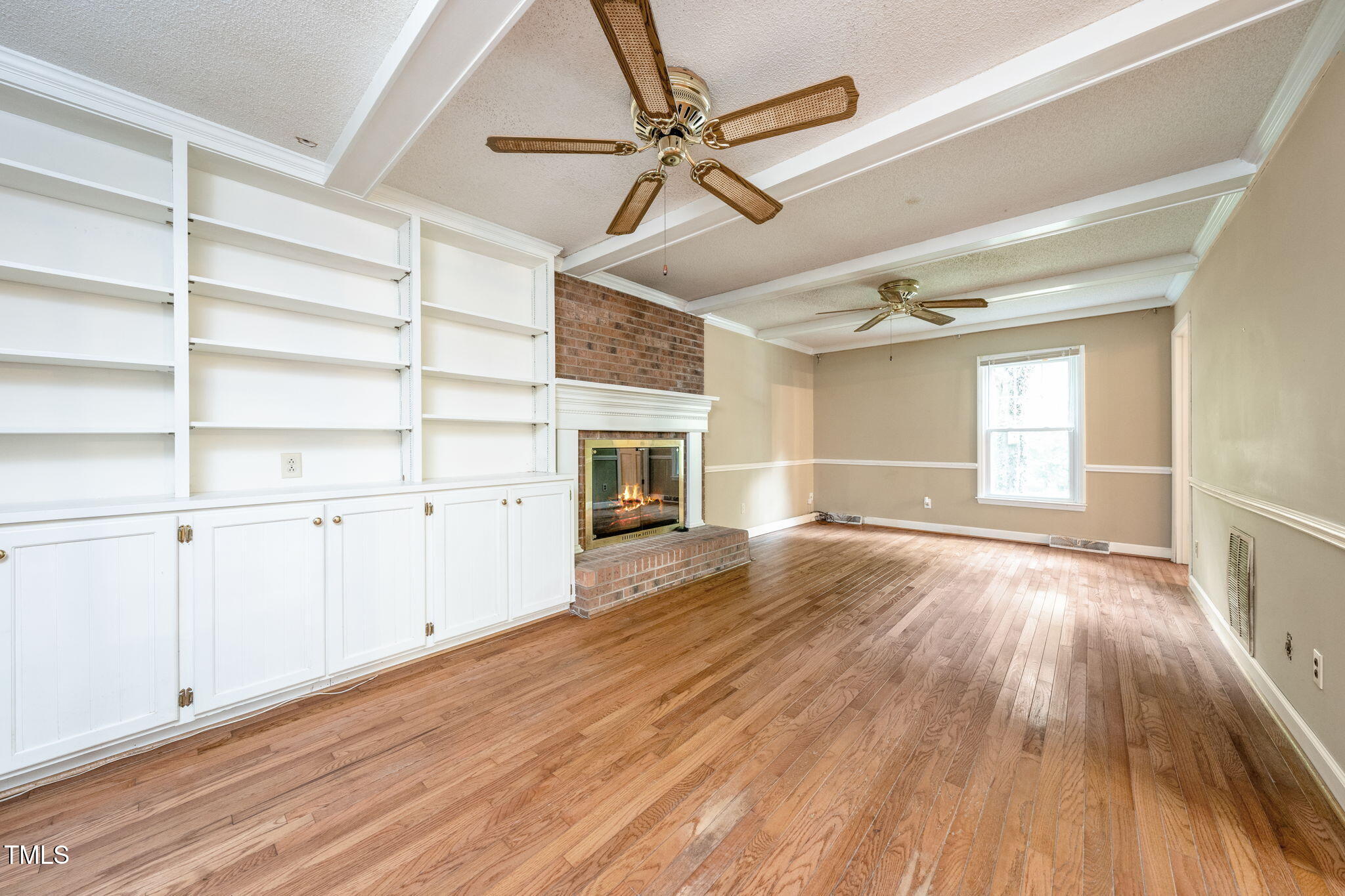 6221 Rushingbrook Drive Raleigh, NC 27612 - Photo 13 of 30 a view of an empty room with a window and fireplace