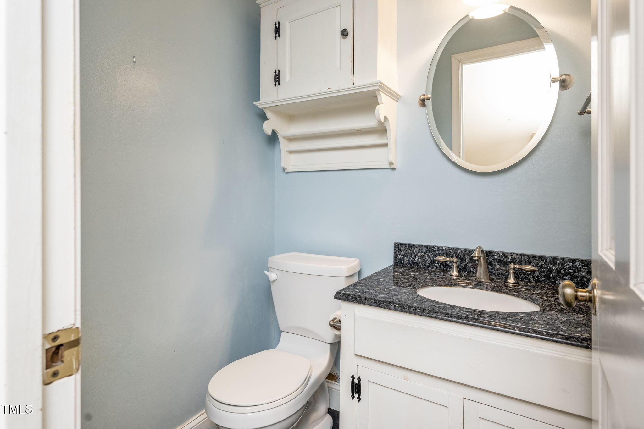 6221 Rushingbrook Drive Raleigh, NC 27612 - Photo 16 of 30 a bathroom with a granite countertop toilet sink and mirror