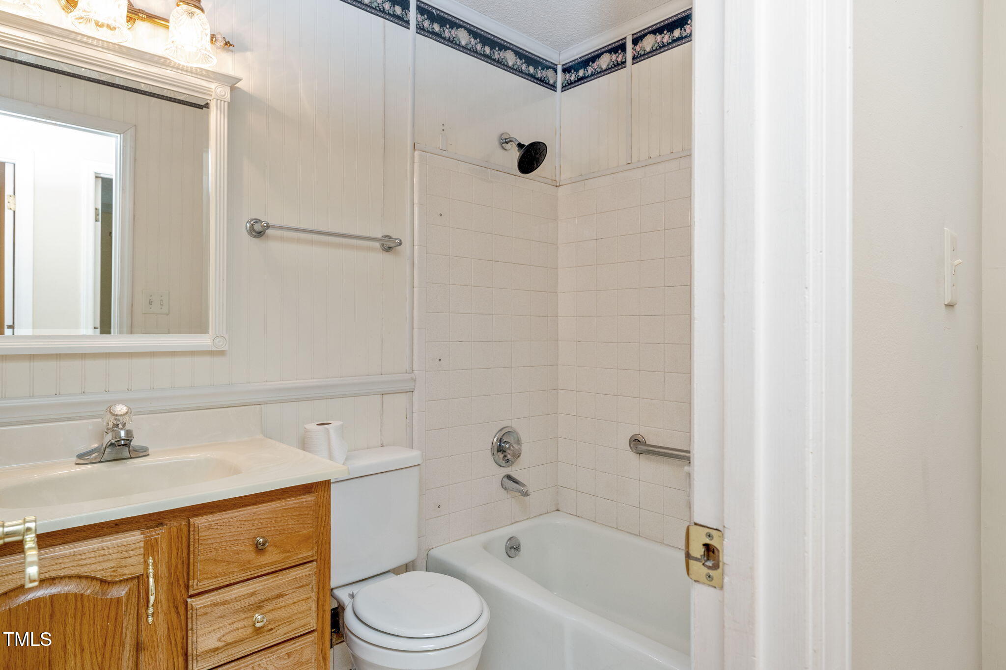 6221 Rushingbrook Drive Raleigh, NC 27612 - Photo 24 of 30 a bathroom with a granite countertop sink a toilet and shower