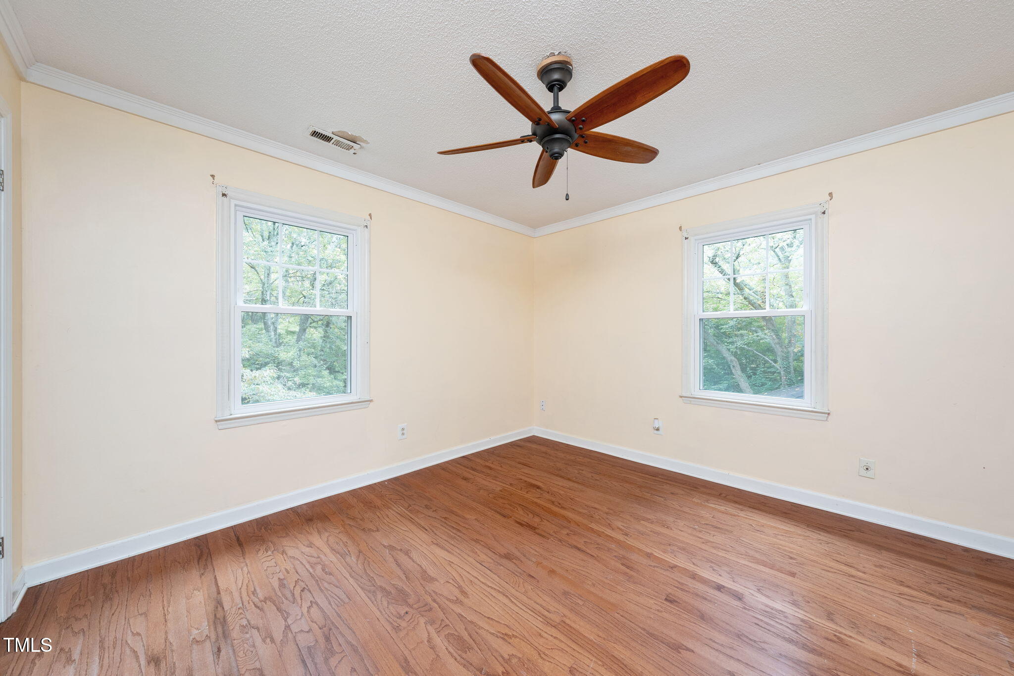 6221 Rushingbrook Drive Raleigh, NC 27612 - Photo 25 of 30 a view of empty room with wooden floor and window