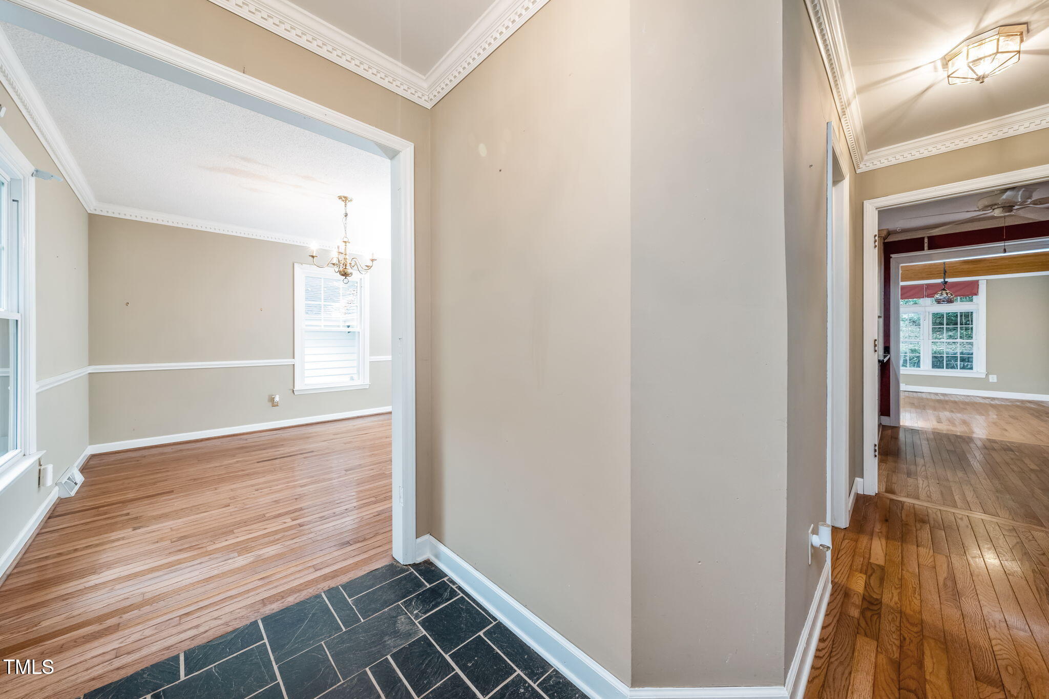 6221 Rushingbrook Drive Raleigh, NC 27612 - Photo 3 of 30 a view of an empty room with wooden floor and a window