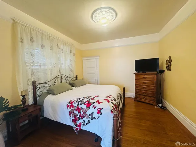 a bedroom with a bed and a flat screen tv