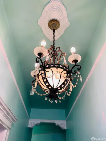 a view of a dining room with furniture and a chandelier