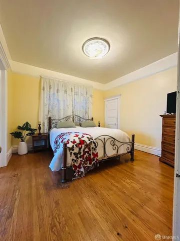 a bedroom with furniture and a large window