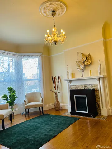 a living room with furniture a fireplace and a table