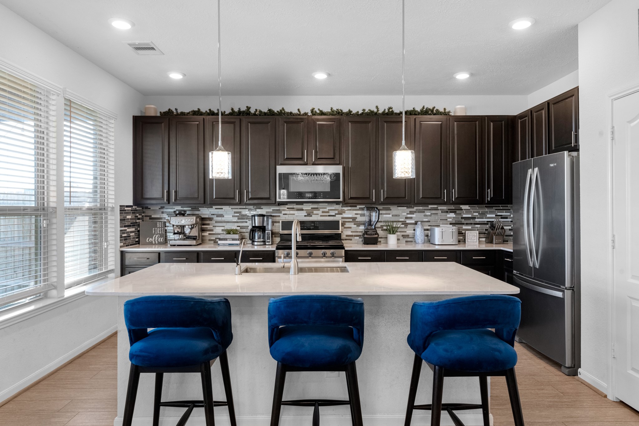 5126 Avondale Rise Street Katy, TX 77493 - Photo 14 of 28 This light and bright kitchen features a large quartz island, custom stained cabinets, a large sink overlooking your family room, recessed lighting, and beautiful backsplash.