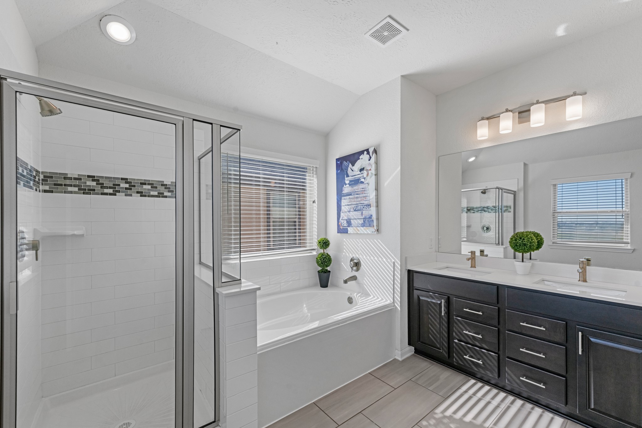 5126 Avondale Rise Street Katy, TX 77493 - Photo 19 of 28 The en-suite bathroom offers a spa-like atmosphere with its elegant design, high end finishes, and tasteful lighting, creating a retreat within your own home.