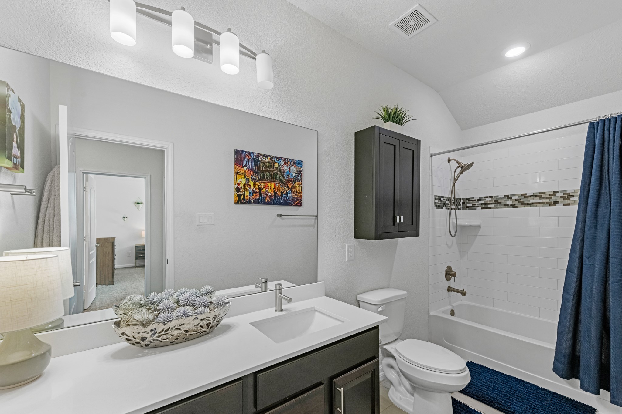 5126 Avondale Rise Street Katy, TX 77493 - Photo 21 of 28 The secondary bath features tile flooring, custom stained cabinetry and light countertops and a shower/tub combo. Perfect for accommodating any visiting family and friends.