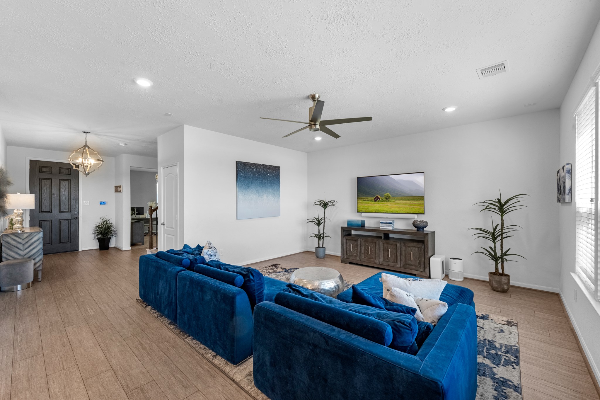 5126 Avondale Rise Street Katy, TX 77493 - Photo 8 of 28 Your family room has ample space to entertain family and friends. This space features beautiful floors, fresh paint, ceiling fan with lighting, and high ceilings.