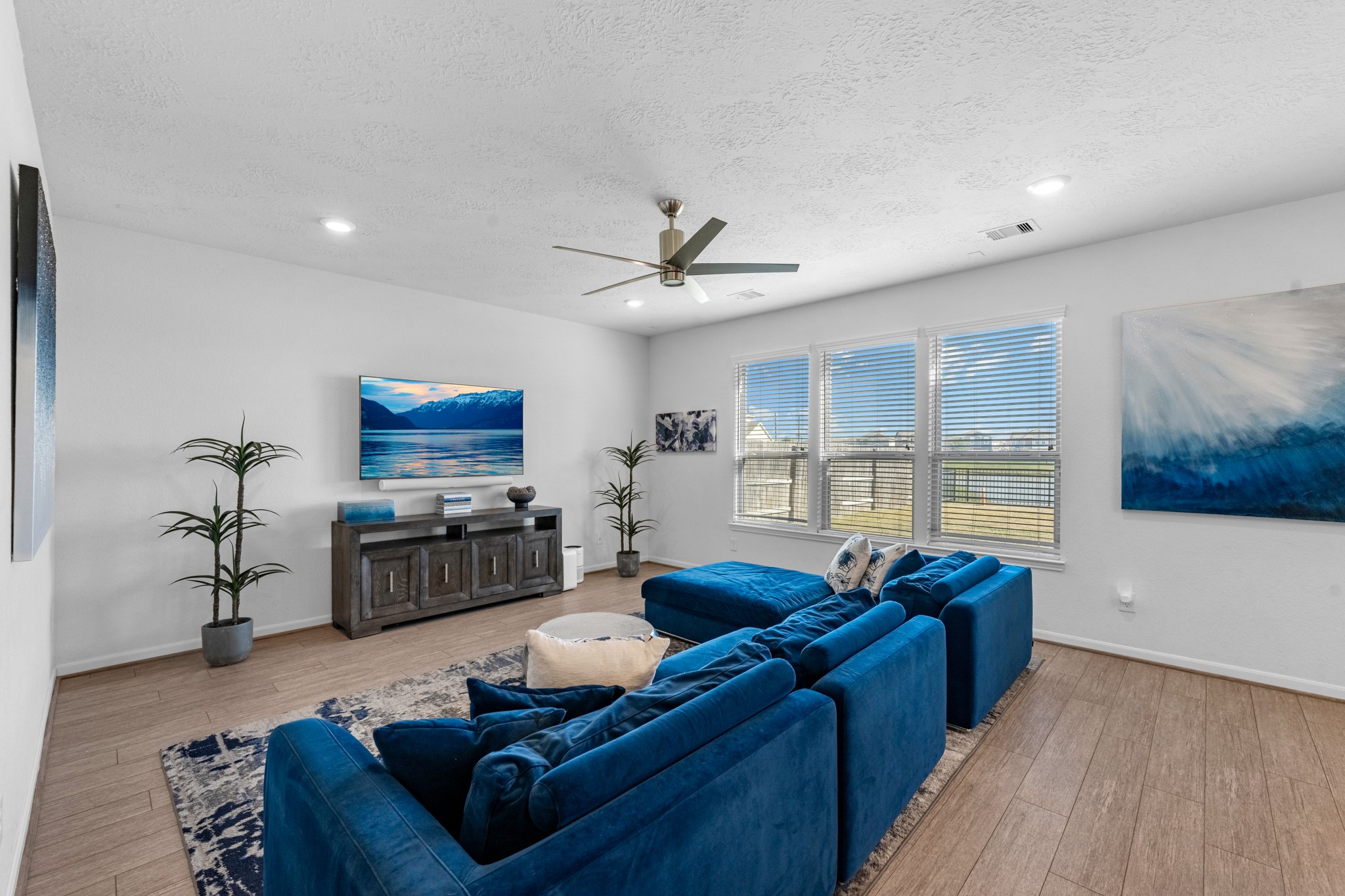 5126 Avondale Rise Street Katy, TX 77493 - Photo 9 of 28 Spacious family room filled with natural light and stunning views of the backyard and community lake.