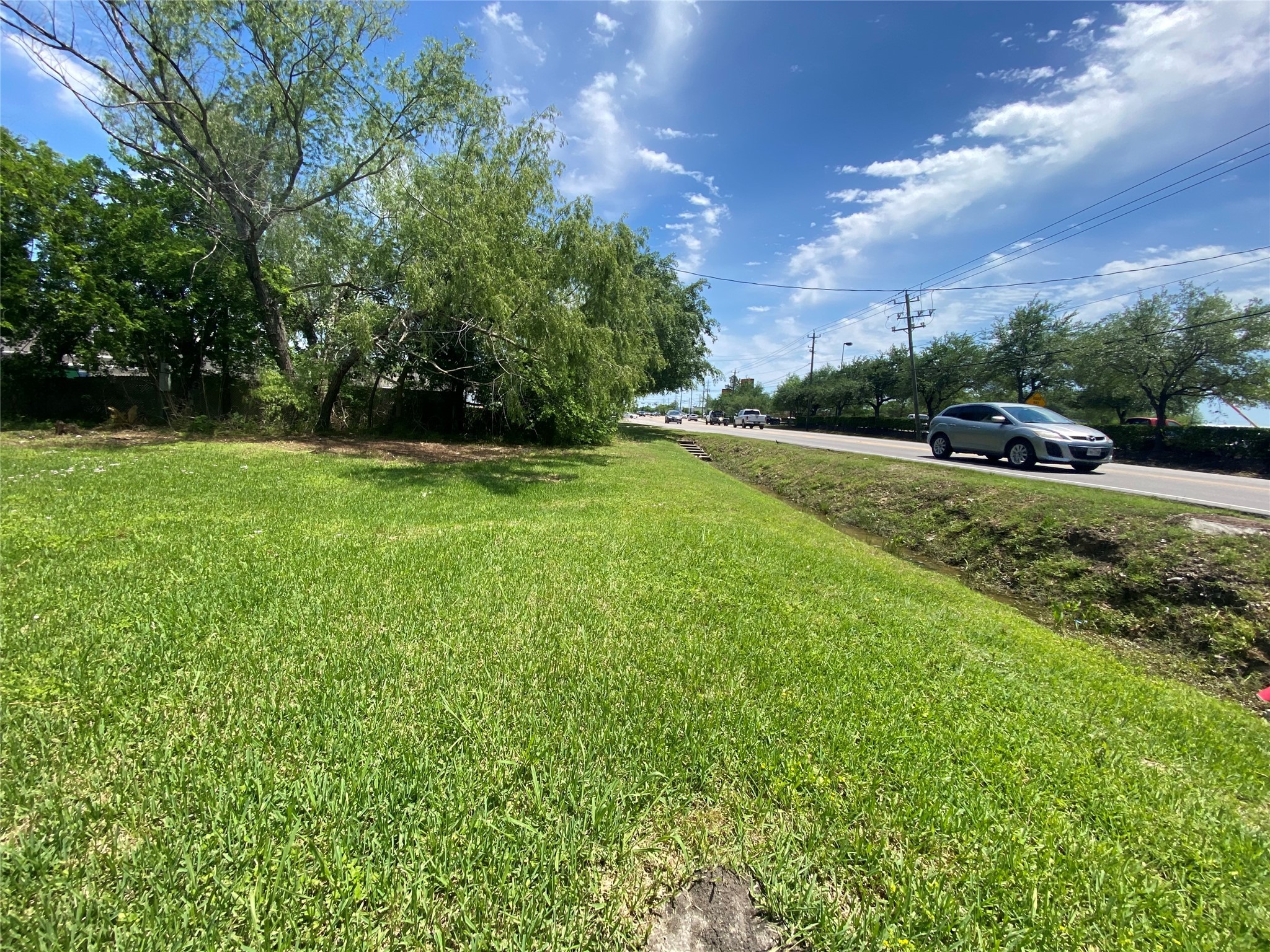 926 West Cedar Bayou Lynchburg Road Baytown, TX 77521 - Photo 7 of 10 a view of field with grass and trees in the background