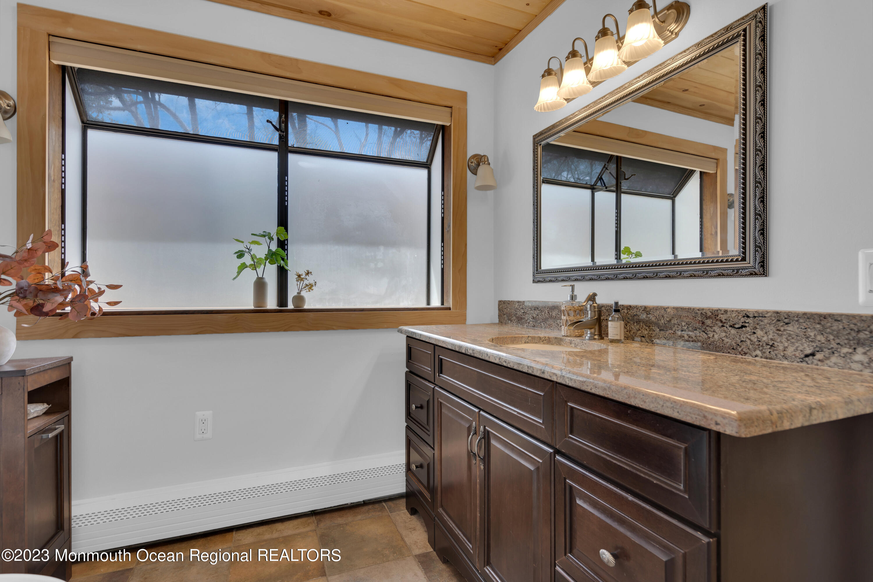 649 Hyson Road Jackson, NJ 08527 - Photo 29 of 67 a bathroom with a granite countertop sink and a mirror