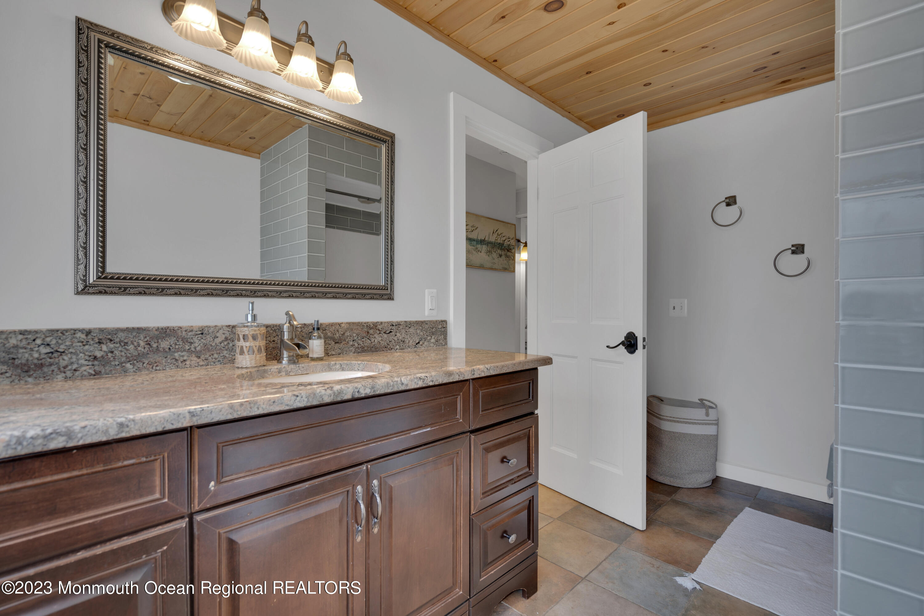 649 Hyson Road Jackson, NJ 08527 - Photo 30 of 67 a bathroom with a granite countertop sink a toilet and a mirror