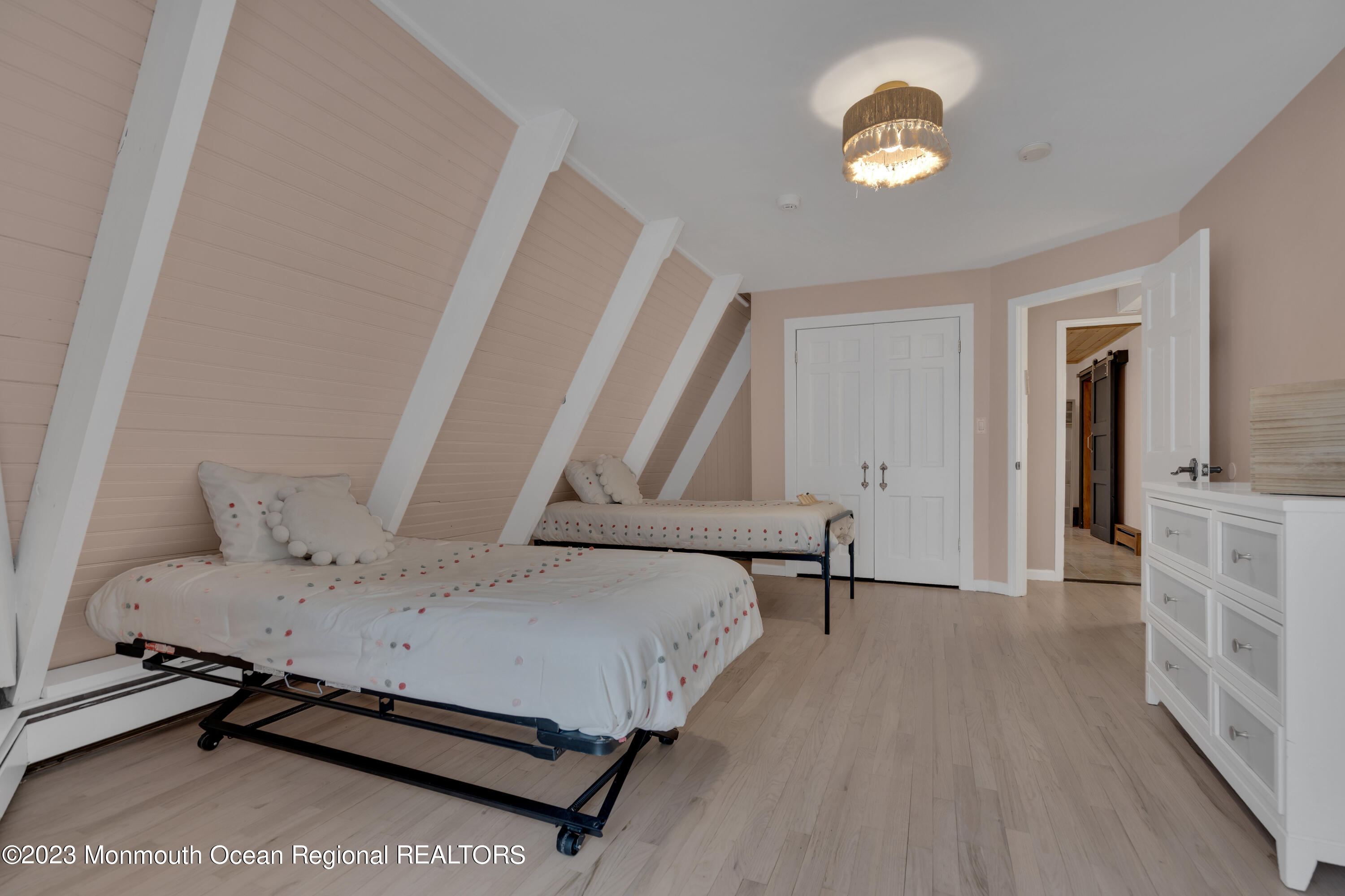 649 Hyson Road Jackson, NJ 08527 - Photo 35 of 67 a bedroom with a bed and a chandelier