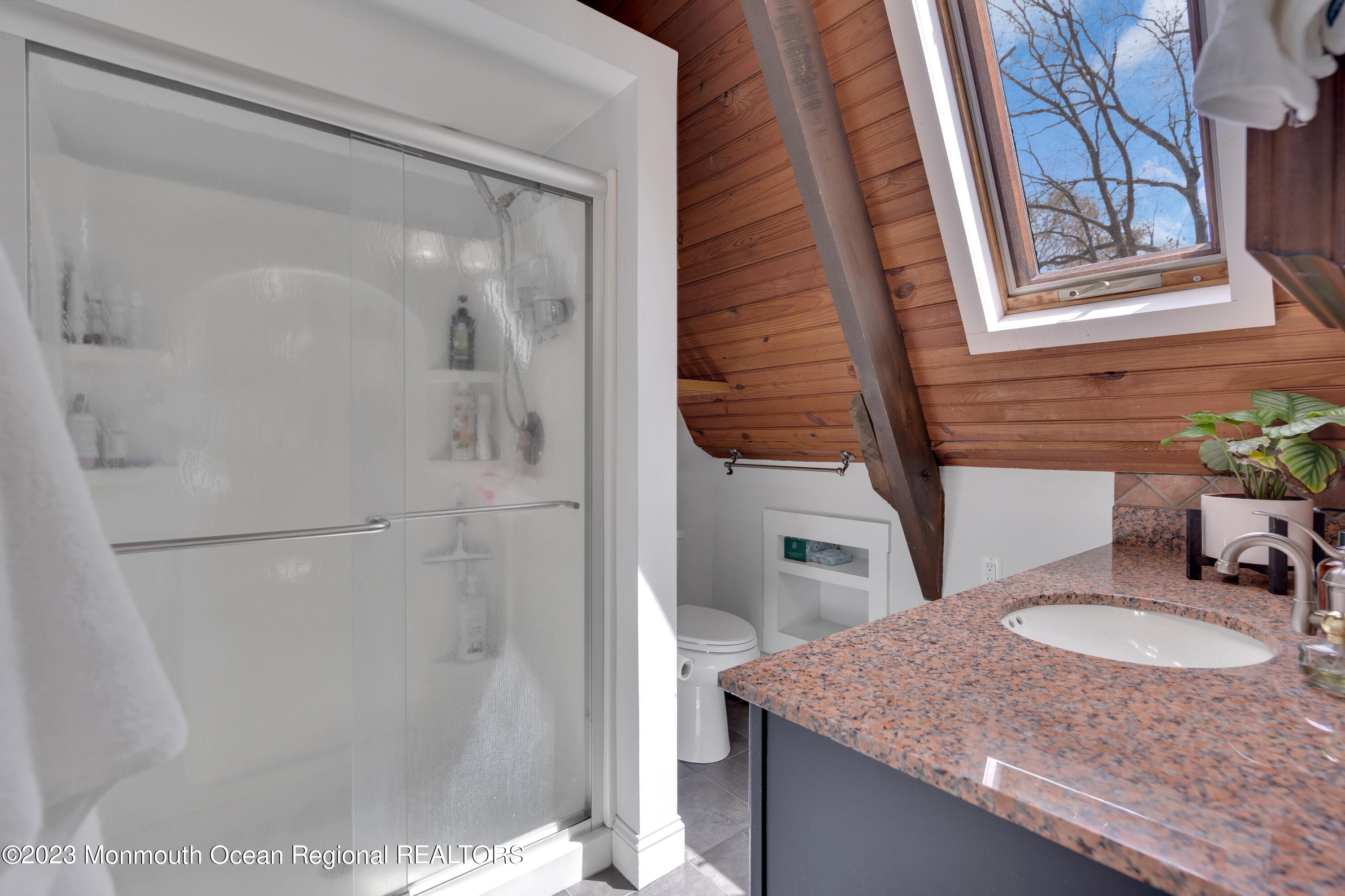 649 Hyson Road Jackson, NJ 08527 - Photo 47 of 67 a bathroom with a granite countertop sink a mirror and shower