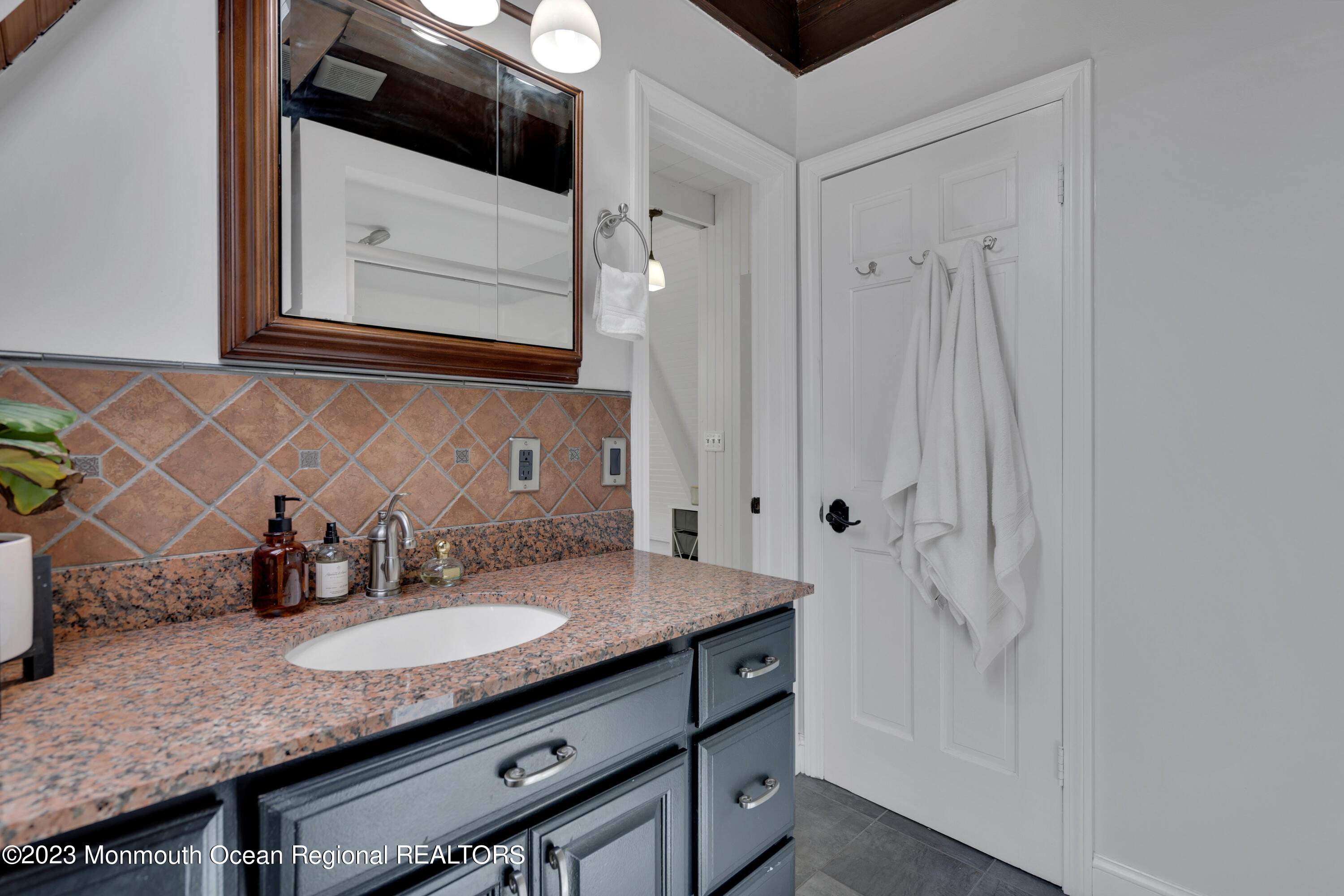 649 Hyson Road Jackson, NJ 08527 - Photo 48 of 67 a bathroom with a granite countertop sink and a mirror