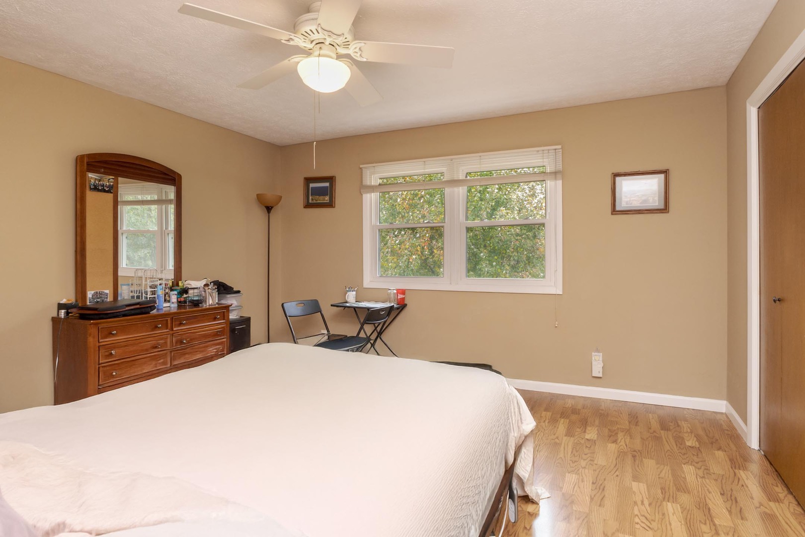 105 East Lincoln Street, Unit K Normal, IL 61761 - Photo 12 of 35 a bedroom with a large bed and a chandelier