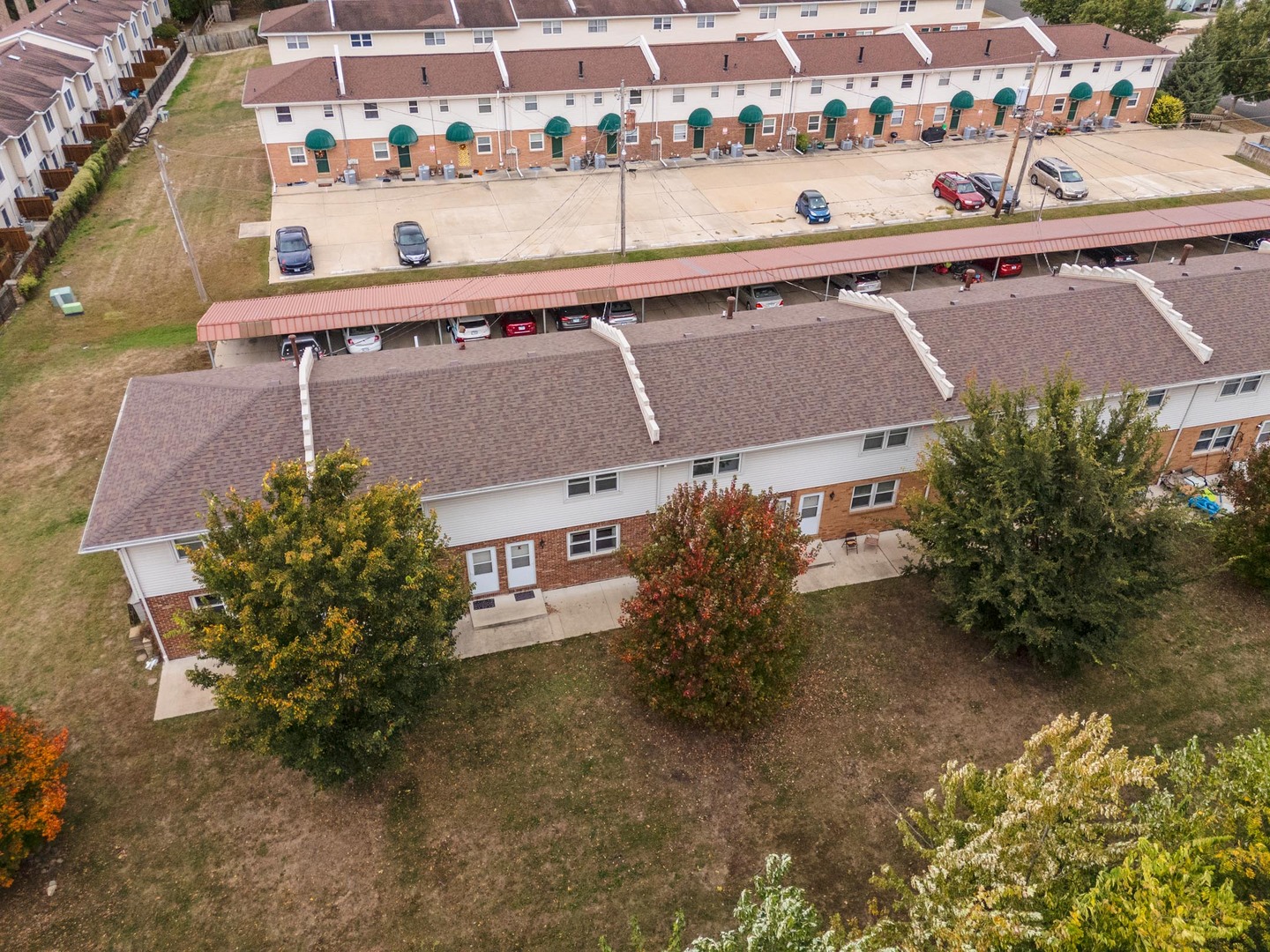 105 East Lincoln Street, Unit K Normal, IL 61761 - Photo 8 of 35 an aerial view of a house with a yard and lake view